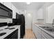 Bright kitchen with white cabinets and modern appliances including black microwave and stove at 6450 Wellington Chase Ct, Lithonia, GA 30058