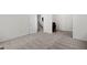 Neutral living area with carpet and white walls, bathed in natural light, offers an open and welcoming space at 6450 Wellington Chase Ct, Lithonia, GA 30058
