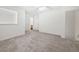 Spacious living area with neutral carpet and bright light with a partial view of a connected bathroom at 6450 Wellington Chase Ct, Lithonia, GA 30058