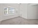 Bright, neutral living room with plush carpet and lots of natural light at 6450 Wellington Chase Ct, Lithonia, GA 30058