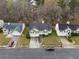 Aerial view of a charming home with a well-manicured lawn, two-car garage, and inviting curb appeal in a neighborhood at 174 Whetstone Way, Villa Rica, GA 30180