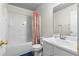 Bathroom featuring a shower-tub combination with white vanity and floral shower curtain at 174 Whetstone Way, Villa Rica, GA 30180