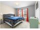 Cozy bedroom with a queen size bed, carpeted floors, and natural light at 174 Whetstone Way, Villa Rica, GA 30180