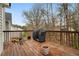 A wood deck with a grill and plants at 174 Whetstone Way, Villa Rica, GA 30180