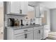Kitchen features white cabinets, granite countertops, and stainless steel appliances at 174 Whetstone Way, Villa Rica, GA 30180