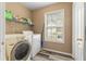 Laundry room features modern washer and dryer, with storage shelf at 174 Whetstone Way, Villa Rica, GA 30180