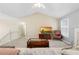 Bright living room area featuring carpet floors, a large window, and comfortable furnishings at 174 Whetstone Way, Villa Rica, GA 30180