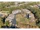 Overhead view of townhomes featuring mature landscaping, playgrounds, and plentiful parking on a sunny day at 407 The Crossings Ln, Woodstock, GA 30189