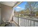 This outdoor balcony with a chair and views of the neighborhood at 407 The Crossings Ln, Woodstock, GA 30189