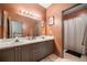 Well-lit bathroom features a double vanity, framed mirror and neutral color palette at 407 The Crossings Ln, Woodstock, GA 30189