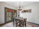 Charming dining area with natural light and stylish chandelier at 407 The Crossings Ln, Woodstock, GA 30189