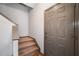 Entryway with carpeted stairs and a neutral-colored front door at 407 The Crossings Ln, Woodstock, GA 30189