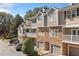Apartment building exterior with stone accents, garages and balconies at 407 The Crossings Ln, Woodstock, GA 30189