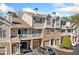Charming townhome with stone accents, private garages, balconies, and well-manicured landscaping at 407 The Crossings Ln, Woodstock, GA 30189