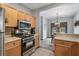 Well-lit kitchen featuring stainless steel appliances, light wood cabinets, and an open design at 407 The Crossings Ln, Woodstock, GA 30189