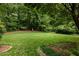 Expansive backyard with lush green grass and mature trees at 4183 Paran Pines Nw Dr, Atlanta, GA 30327