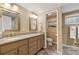 Bathroom with granite countertops, cabinets, and modern tile floors at 4183 Paran Pines Nw Dr, Atlanta, GA 30327
