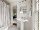 Classic bathroom with pedestal sink, and neutral tones, offering a clean and functional space with natural light at 4183 Paran Pines Nw Dr, Atlanta, GA 30327