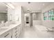 Elegant bathroom featuring a soaking tub, a walk-in shower, and dual sinks offering a spa-like experience at 4183 Paran Pines Nw Dr, Atlanta, GA 30327