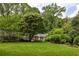 Landscaped lawn with house exterior surrounded by trees at 4183 Paran Pines Nw Dr, Atlanta, GA 30327