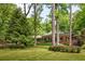 Beautiful single-story brick home with manicured lawn and trees adding privacy and charm at 4183 Paran Pines Nw Dr, Atlanta, GA 30327