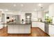 Bright kitchen boasts white cabinets, stainless appliances, an island and hardwood floors at 4183 Paran Pines Nw Dr, Atlanta, GA 30327