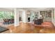 Open-concept living room with hardwood floors, fireplace, and dining area for comfortable living and entertaining at 4183 Paran Pines Nw Dr, Atlanta, GA 30327
