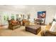 Inviting living room with plush seating, a classic fireplace, and lots of natural light streaming through French doors at 4183 Paran Pines Nw Dr, Atlanta, GA 30327