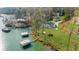An aerial view of stunning waterfront property with lush green lawns and private docks at 6313 Shoreland Cir, Buford, GA 30518