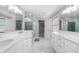 Luxurious bathroom with quartz counters, dual sinks, updated fixtures, and a sleek tile shower at 6313 Shoreland Cir, Buford, GA 30518