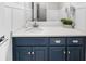 Bright bathroom with white counter tops, blue vanity, and modern hardware at 6313 Shoreland Cir, Buford, GA 30518