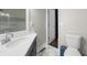 Modern bathroom with white marble tile floor and blue vanity at 6313 Shoreland Cir, Buford, GA 30518