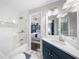 Elegant bathroom features white subway tile in the shower and blue vanity at 6313 Shoreland Cir, Buford, GA 30518