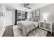 Light-filled bedroom boasts soft grays, modern decor and a large window at 6313 Shoreland Cir, Buford, GA 30518