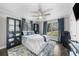 Bright bedroom features a ceiling fan, large windows, and blue accents at 6313 Shoreland Cir, Buford, GA 30518