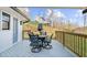 Deck with a table and chairs that offers a scenic view of a backyard and natural surroundings at 6313 Shoreland Cir, Buford, GA 30518