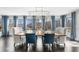 Dining room featuring a statement chandelier, lake views, and seating for six at 6313 Shoreland Cir, Buford, GA 30518