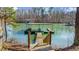 Dock leading out to a covered boat slip and lake access at 6313 Shoreland Cir, Buford, GA 30518