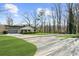 Charming exterior of a home with a well-manicured lawn, attached garage, and lush landscaping at 6313 Shoreland Cir, Buford, GA 30518