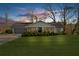 Twilight view of a beautifully landscaped home with a well-lit front yard at 6313 Shoreland Cir, Buford, GA 30518
