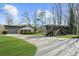 Exterior view of a charming home with a well-manicured lawn and RV parked in the driveway at 6313 Shoreland Cir, Buford, GA 30518