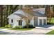 Garage/workshop with three bays attached to the main building is surrounded by landscaping at 6313 Shoreland Cir, Buford, GA 30518