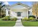 Home's inviting front entrance features a covered porch with sturdy wooden pillars and manicured landscaping at 6313 Shoreland Cir, Buford, GA 30518