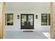 Close-up of the front porch with decorative door and sidelights, featuring modern outdoor lighting at 6313 Shoreland Cir, Buford, GA 30518