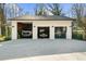Detached garage featuring three parking bays for vehicles and equipment at 6313 Shoreland Cir, Buford, GA 30518