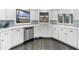 Bright kitchen with white cabinets, stainless steel appliances, and granite countertops at 6313 Shoreland Cir, Buford, GA 30518
