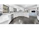 Bright kitchen with white countertops, cabinets, stainless steel appliances, and dark flooring at 6313 Shoreland Cir, Buford, GA 30518