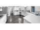 Modern kitchen with stainless steel appliances, white cabinets, countertops, and dark wood flooring at 6313 Shoreland Cir, Buford, GA 30518