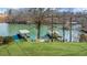 Breathtaking view of a private lake featuring covered boat docks and a gazebo deck area at 6313 Shoreland Cir, Buford, GA 30518