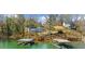 Stunning lake view homes featuring private docks and stairs leading up to the house at 6313 Shoreland Cir, Buford, GA 30518